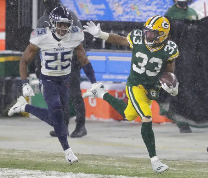 Green Bay Packers running back Aaron Jones (33) runs for a long gain against Tennessee Titans cornerback Adoree' Jackson (25) in the third quarter during their football game Sunday, December 27, 2020, at Lambeau Field in Green Bay, Wis. Dan Powers/USA TODAY NETWORK-Wisconsin