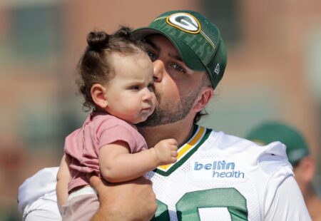 Green Bay Packers offensive tackle David Bakhtiari (69) kisses his daughter Felix as he walks to training camp Thursday, July 27, 2023, at Ray Nitschke Field in Green Bay, Wis.Dan Powers/USA TODAY NETWORK-Wisconsin.