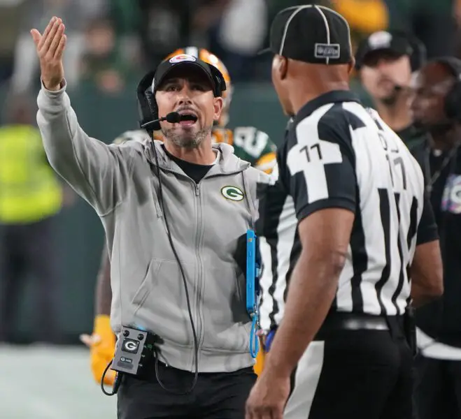 Sep 28, 2023; Green Bay, Wisconsin, USA; Green Bay Packers head coach Matt LaFleur talks with umpire Fred Bryan (11) during the fourth quarter at Lambeau Field. Mandatory Credit: Mark Hoffman-USA TODAY Sports