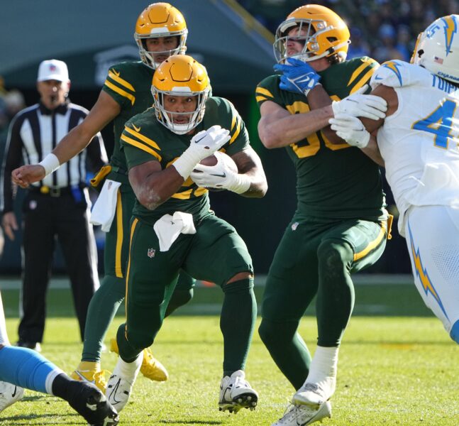 Green Bay Packers running back AJ Dillon (28) runs for a first down during the second quarter of their game against the Los Angeles Chargers Sunday, November 19, 2023 at Lambeau Field in Green Bay, Wisconsin. © Mark Hoffman / USA TODAY NETWORK