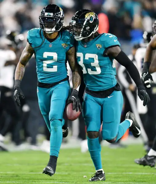 Jacksonville Jaguars linebacker Devin Lloyd (33) celebrates with teammate safety Rayshawn Jenkins (2) after Jenkins intercepted a Ravens pass early in the second quarter. The Jacksonville Jaguars hosted the Baltimore Ravens at EverBank Stadium in Jacksonville, Florida Sunday Night, December 17, 2023. The Jaguars trailed 10 to 0 at the half. [Bob Self/Florida Times-Union]