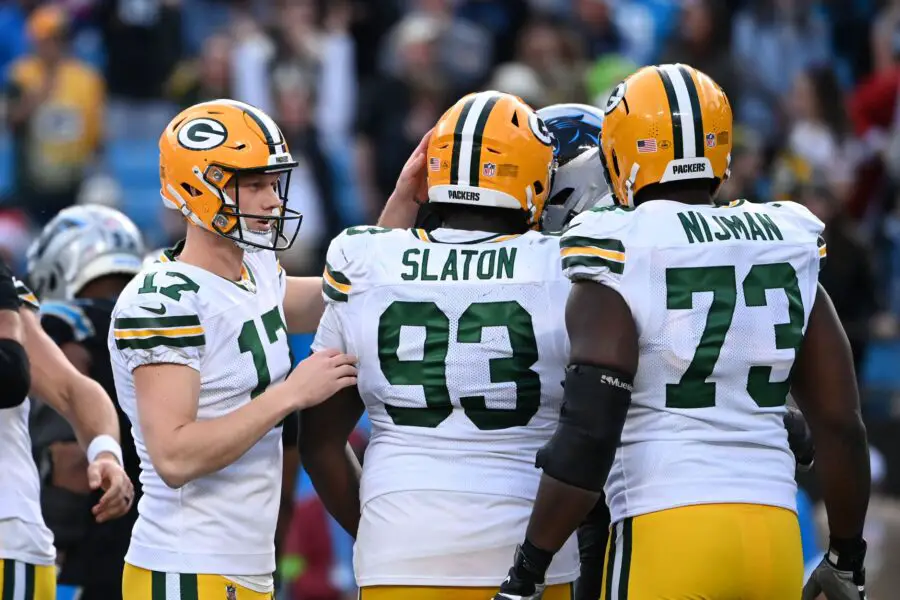 Dec 24, 2023; Charlotte, North Carolina, USA; Green Bay Packers place kicker Anders Carlson (17) with defensive tackle T.J. Slaton (93) and offensive tackle Yosh Nijman (73) after kicking the game winning field goal in the fourth quarter at Bank of America Stadium. Mandatory Credit: Bob Donnan-USA TODAY Sports