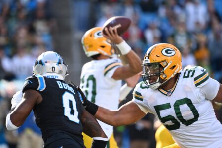 Dec 24, 2023; Charlotte, North Carolina, USA; Green Bay Packers guard Zach Tom (50) blocks Carolina Panthers linebacker Brian Burns (0) as quarterback Jordan Love (10) attempts to pass in the second quarter at Bank of America Stadium. Mandatory Credit: Bob Donnan-USA TODAY Sports