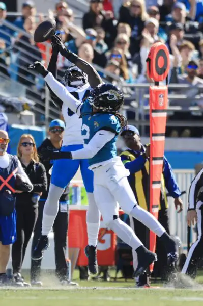 Jacksonville Jaguars safety Rayshawn Jenkins (2) bats a pass away from Carolina Panthers tight end Stephen Sullivan (84) during the first quarter of a regular season NFL football matchup Sunday, Dec. 31, 2023 at EverBank Stadium in Jacksonville, Fla. [Corey Perrine/Florida Times-Union]
