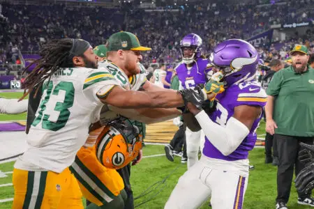 Dec 31, 2023; Minneapolis, Minnesota, USA; Green Bay Packers running back Aaron Jones (33) and Minnesota Vikings cornerback Andrew Booth Jr. (23) push each other after the game at U.S. Bank Stadium. Mandatory Credit: Brad Rempel-USA TODAY Sports