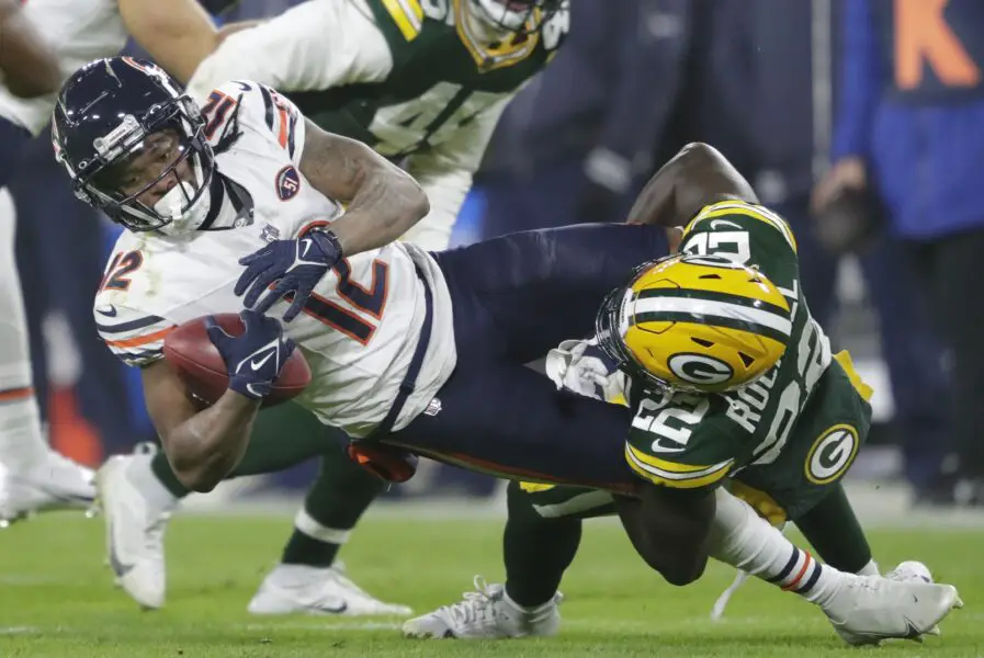 Jan 7, 2024; Green Bay, Wisconsin, USA; Green Bay Packers cornerback Robert Rochell (22) tackles Chicago Bears wide receiver Velus Jones Jr. (12) at the ten yard line on a kick off return during their football game at Lambeau Field. Mandatory Credit: Dan Powers-USA TODAY Sports