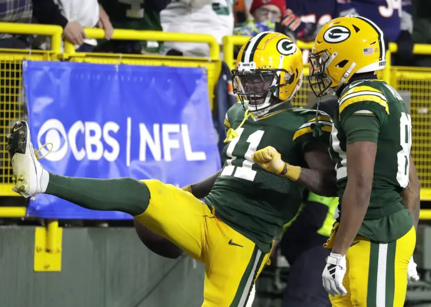 Jan 7, 2024; Green Bay, Wisconsin, USA; Green Bay Packers wide receiver Jayden Reed (11) and wide receiver Bo Melton (80) celebrate a reception against the Chicago Bears during their football game at Lambeau Field. Mandatory Credit: Wm. Glasheen-USA TODAY Sports