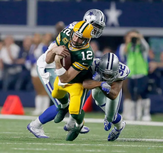 Green Bay Packers quarterback Aaron Rodgers (12) is tackled after getting a first down during the 4th quarter of the 34-31 Green Bay Packers divisional playoff game win against the Dallas Cowboys at AT&T Stadium in Arlington, Texas on January 15, 2017. © Mike De Sisti / Milwaukee Journal Sentinel / USA TODAY NETWORK