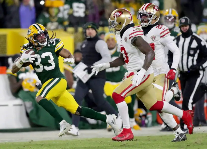 Green Bay Packers running back Aaron Jones (33) runs for a long gain late in the second quarter of the divisional playoff game against the San Francisco 49ers at Lambeau Field in Green Bay on Saturday, Jan. 22, 2022.