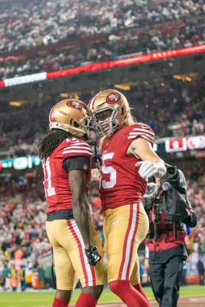 January 20, 2024; Santa Clara, CA, USA; San Francisco 49ers tight end George Kittle (85) is congratulated by wide receiver Brandon Aiyuk (11) after scoring a touchdown during the second quarter in a 2024 NFC divisional round game against the Green Bay Packers at Levi's Stadium. Mandatory Credit: Kyle Terada-USA TODAY Sports