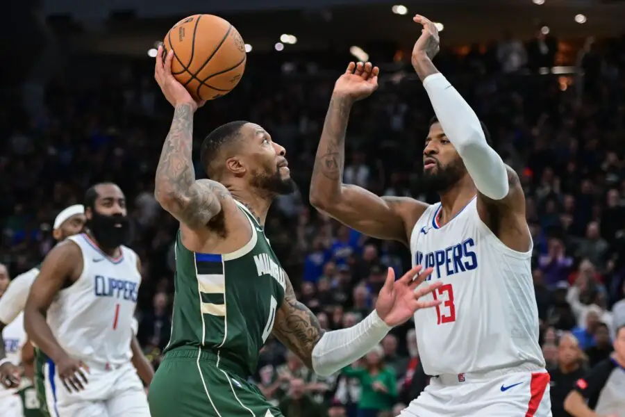 Mar 4, 2024; Milwaukee, Wisconsin, USA; Milwaukee Bucks guard Damian Lillard (0) drives for the basket against Los Angeles Clippers forward Paul George (13) in the fourth quarter at Fiserv Forum. Mandatory Credit: Benny Sieu-USA TODAY Sports