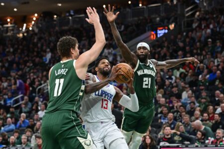 Mar 4, 2024; Milwaukee, Wisconsin, USA; Los Angeles Clippers forward Paul George (13) takes a shot between Milwaukee Bucks center Brook Lopez (11) and guard Patrick Beverley (21) in the second quarter at Fiserv Forum. Mandatory Credit: Benny Sieu-USA TODAY Sports