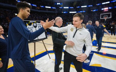 Marquette forward Oso Ighodaro, left, greets guard Tyler Kolek after being honored on senior day before their game against UConn Wednesday, March 6, 2024 at Fiserv Forum in Milwaukee, Wisconsin.