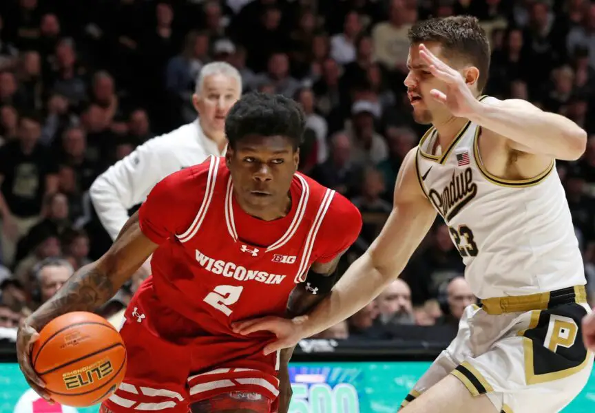 Wisconsin Badgers guard AJ Storr (2) drives into Purdue Boilermakers forward Camden Heide (23) during the NCAA men’s basketball game, Sunday, March 10, 2024, at Mackey Arena in West Lafayette, Ind.