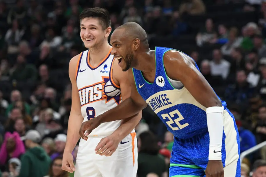Mar 17, 2024; Milwaukee, Wisconsin, USA; Phoenix Suns guard Grayson Allen (8) and former teammate Milwaukee Bucks forward Khris Middleton (22) share a few laughs during the game at Fiserv Forum. Mandatory Credit: Michael McLoone-USA TODAY Sports