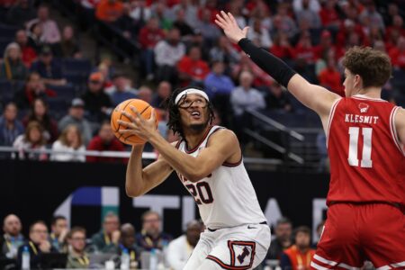 Mar 17, 2024; Minneapolis, MN, USA; Illinois Fighting Illini forward Ty Rodgers (20) looks to the basket defend by Wisconsin Badgers guard Max Klesmit (11) in the second half at Target Center. Mandatory Credit: Matt Krohn-USA TODAY Sports