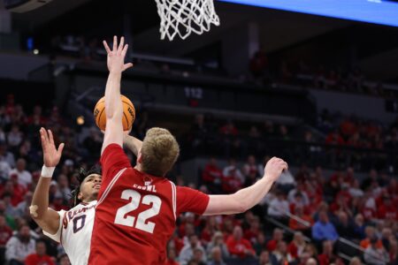 Mar 17, 2024; Minneapolis, MN, USA; Illinois Fighting Illini guard Terrence Shannon Jr. (0) shoots the ball over Wisconsin Badgers forward Steven Crowl (22) in the second half at Target Center. Mandatory Credit: Matt Krohn-USA TODAY Sports