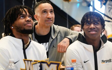 Marquette Golden Eagles Head Coach Shaka Smart shares a moment with his players junior forward David Joplin and freshman guard Zaide Lowery, right, on Selection Sunday at MECCA Bar and Grill in Milwaukee. The Golden Eagles will take on the Western Kentucky Hilltoppers in Indianapolis in the first round of the 2024 NCAA Tournament.