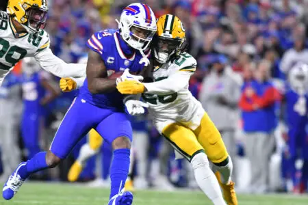 Oct 30, 2022; Orchard Park, New York, USA; Buffalo Bills wide receiver Stefon Diggs (14) is tackled by Green Bay Packers safety Darnell Savage (26) after a catch in the second quarter at Highmark Stadium. Mandatory Credit: Mark Konezny-USA TODAY Sports