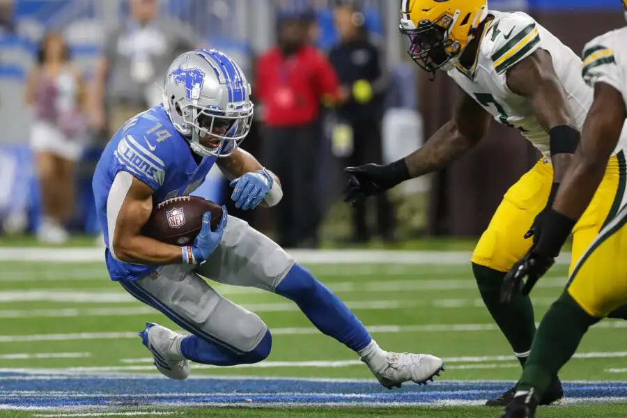 Nov 6, 2022; Detroit, Michigan, USA; Detroit Lions wide receiver Amon-Ra St. Brown (14) slides for a first down against Green Bay Packers during the first half at Ford Field. Mandatory Credit: Junfu Han-USA TODAY Sports