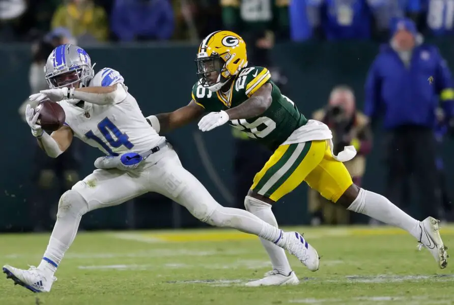 Detroit Lions wide receiver Amon-Ra St. Brown (14) catches a pass in front of Green Bay Packers safety Darnell Savage (26) during their football game on Sunday, January, 8, 2022 at Lambeau Field in Green Bay, Wis. Wm. Glasheen USA TODAY NETWORK-Wisconsin