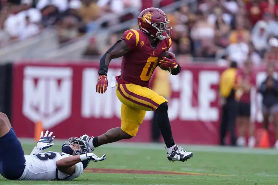 Sep 2, 2023; Los Angeles, California, USA; Southern California Trojans running back MarShawn Lloyd (0) carries the ball against Nevada Wolf Pack defensive back Ezekiel Robbins (13) in the first half at United Airlines Field at Los Angeles Memorial Coliseum. Mandatory Credit: Kirby Lee-USA TODAY Sports (Green Bay Packers)
