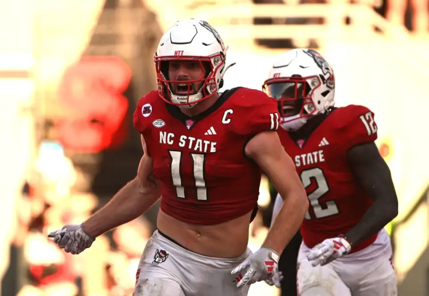 Oct 28, 2023; Raleigh, North Carolina, USA; North Carolina State Wolfpack linebacker Payton Wilson (11) celebrates after scoring a touchdown on an interception during the second half against the Clemson Tigers at Carter-Finley Stadium. Mandatory Credit: Rob Kinnan-USA TODAY Sports
