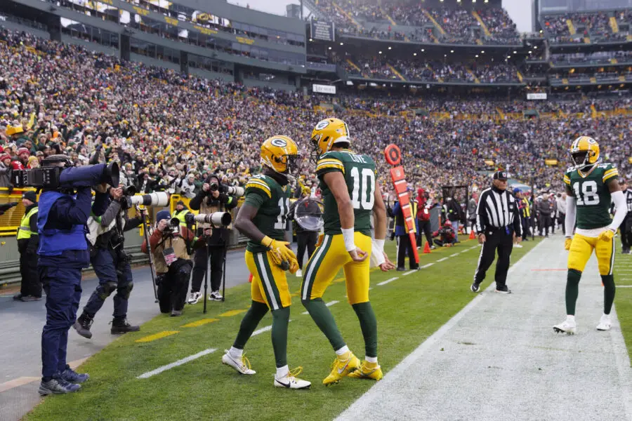 Dec 17, 2023; Green Bay, Wisconsin, USA; Green Bay Packers wide receiver Jayden Reed (11) celebrates with quarterback Jordan Love (10) after scoring a touchdown during the third quarter against the Tampa Bay Buccaneers at Lambeau Field. Mandatory Credit: Jeff Hanisch-USA TODAY Sports