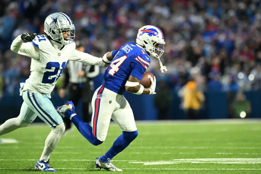 Dec 17, 2023; Orchard Park, New York, USA;  Buffalo Bills wide receiver Stefon Diggs (14) runs the ball pressured by Dallas Cowboys cornerback Stephon Gilmore (21) in the first half at Highmark Stadium. Mandatory Credit: Mark Konezny-USA TODAY Sports (Green Bay Packers)