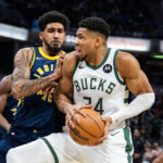 Jan 3, 2024; Indianapolis, Indiana, USA; Milwaukee Bucks forward Giannis Antetokounmpo (34) shoots the ball while Indiana Pacers forward Obi Toppin (1) defends in the first quarter at Gainbridge Fieldhouse. Mandatory Credit: Trevor Ruszkowski-USA TODAY Sports