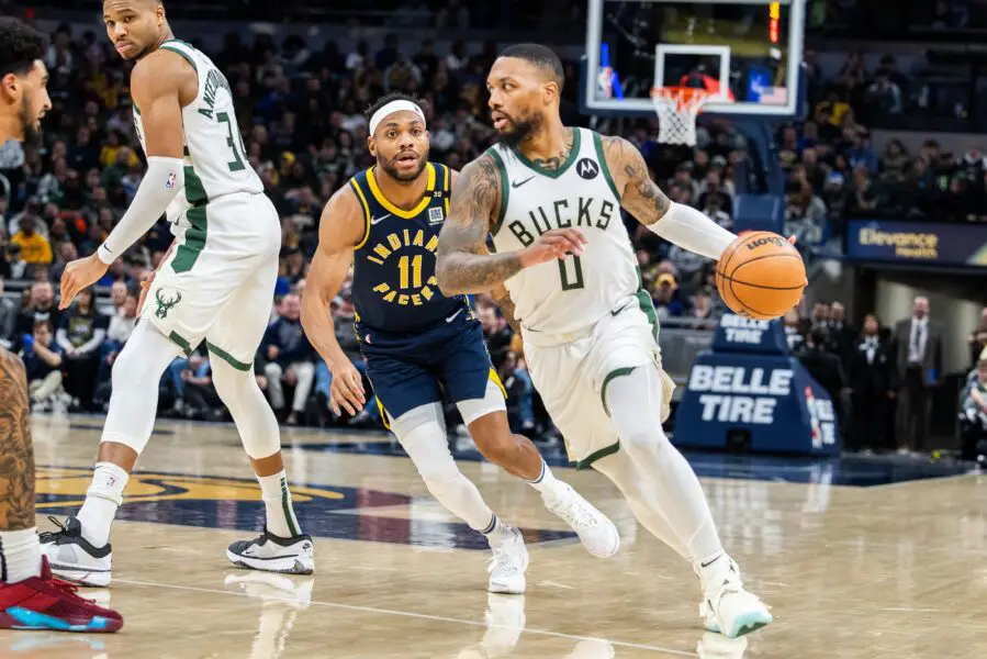 Jan 3, 2024; Indianapolis, Indiana, USA; Milwaukee Bucks guard Damian Lillard (0) dribbles the ball while Indiana Pacers forward Bruce Brown (11) defends in the second quarter at Gainbridge Fieldhouse. Mandatory Credit: Trevor Ruszkowski-USA TODAY Sports