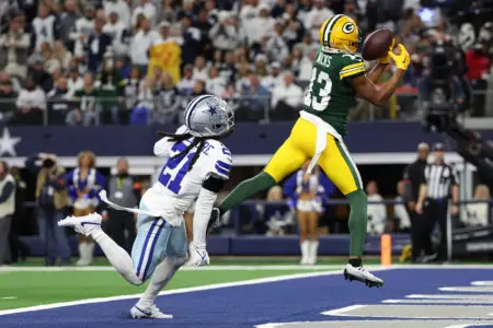 Jan 14, 2024; Arlington, Texas, USA; Green Bay Packers wide receiver Dontayvion Wicks (13) makes a touchdown catch against Dallas Cowboys cornerback Stephon Gilmore (21) in the first half of the 2024 NFC wild card game at AT&T Stadium. Mandatory Credit: Kevin Jairaj-USA TODAY Sports