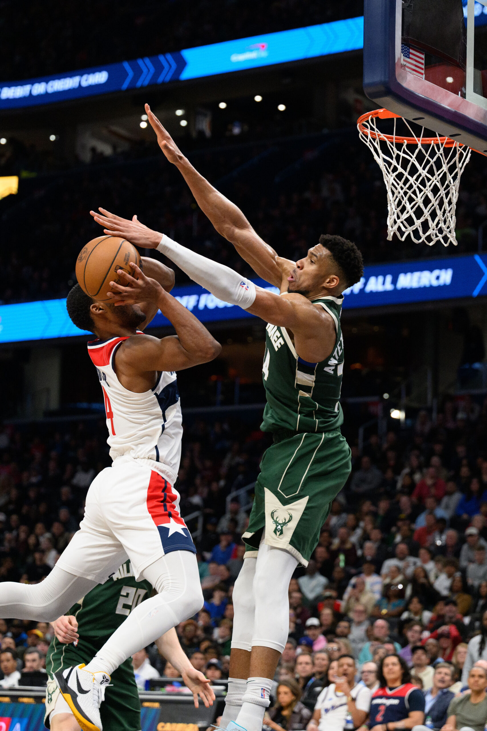 Apr 2, 2024; Washington, District of Columbia, USA; Milwaukee Bucks forward Giannis Antetokounmpo (34) defends against Washington Wizards guard Jared Butler (4) during the fourth quarter at Capital One Arena. Mandatory Credit: Reggie Hildred-USA TODAY Sports