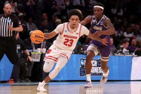 Mar 22, 2024; Brooklyn, NY, USA; Wisconsin Badgers guard Chucky Hepburn (23) drives to the basket against James Madison Dukes guard Xavier Brown (0) during the second half at Barclays Center. Mandatory Credit: Brad Penner-USA TODAY Sports
