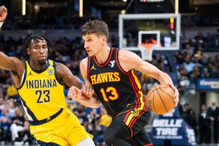 Apr 14, 2024; Indianapolis, Indiana, USA; Atlanta Hawks guard Bogdan Bogdanovic (13) dribbles the ball while Indiana Pacers forward Aaron Nesmith (23) defends in the second half at Gainbridge Fieldhouse. Mandatory Credit: Trevor Ruszkowski-USA TODAY Sports
