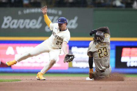 Apr 16, 2024; Milwaukee, Wisconsin, USA; San Diego Padres right fielder Fernando Tatis Jr. (23) steals second base as Milwaukee Brewers shortstop Willy Adames (27) fields the throw during the seventh inning at American Family Field. Mandatory Credit: Jeff Hanisch-USA TODAY Sports