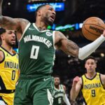 Apr 21, 2024; Milwaukee, Wisconsin, USA; Milwaukee Bucks guard Damian Lillard (0) reach for a rebound against Indiana Pacers guard Tyrese Haliburton (0) in the second quarter during game one of the first round for the 2024 NBA playoffs at Fiserv Forum. Mandatory Credit: Benny Sieu-USA TODAY Sports