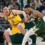 Apr 21, 2024; Milwaukee, Wisconsin, USA; Milwaukee Bucks guard Damian Lillard (0) drives past Indiana Pacers guard T.J. McConnell (9) in the in the third quarter during game one of the first round for the 2024 NBA playoffs at Fiserv Forum. Mandatory Credit: Benny Sieu-USA TODAY Sports