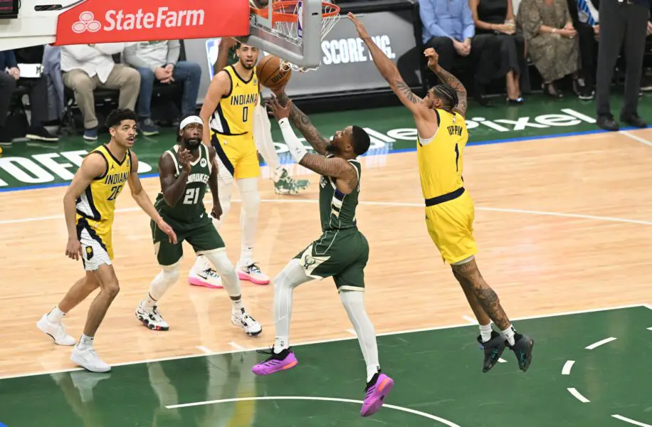 Apr 23, 2024; Milwaukee, Wisconsin, USA;Milwaukee Bucks guard Damian Lillard (0) drives to the basket against Indiana Pacers forward Obi Toppin (1) in the first half during game two of the first round for the 2024 NBA playoffs at Fiserv Forum. Mandatory Credit: Michael McLoone-USA TODAY Sports