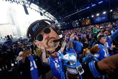 Detroit Lions fans inside the NFL draft theater celebrate as the master of ceremonies recognized them before the start of the draft in Detroit on Thursday, April 25, 2024. © Eric Seals / USA TODAY NETWORK