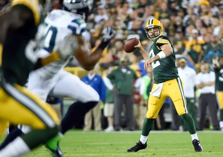 Sep 20, 2015; Green Bay, WI, USA; Green Bay Packers quarterback Aaron Rodgers (12) passes to wide receiver James Jones (not pictured) for a touchdown in the first quarter against the Seattle Seahawks at Lambeau Field. Mandatory Credit: Benny Sieu-USA TODAY Sports