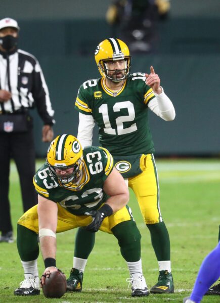 Jan 16, 2021; Green Bay, Wisconsin, USA; Green Bay Packers center Corey Linsley (63) prepares to snap the ball to quarterback Aaron Rodgers (12) against the Los Angeles Rams during the NFC Divisional Round at Lambeau Field. Mandatory Credit: Mark J. Rebilas-USA TODAY Sports