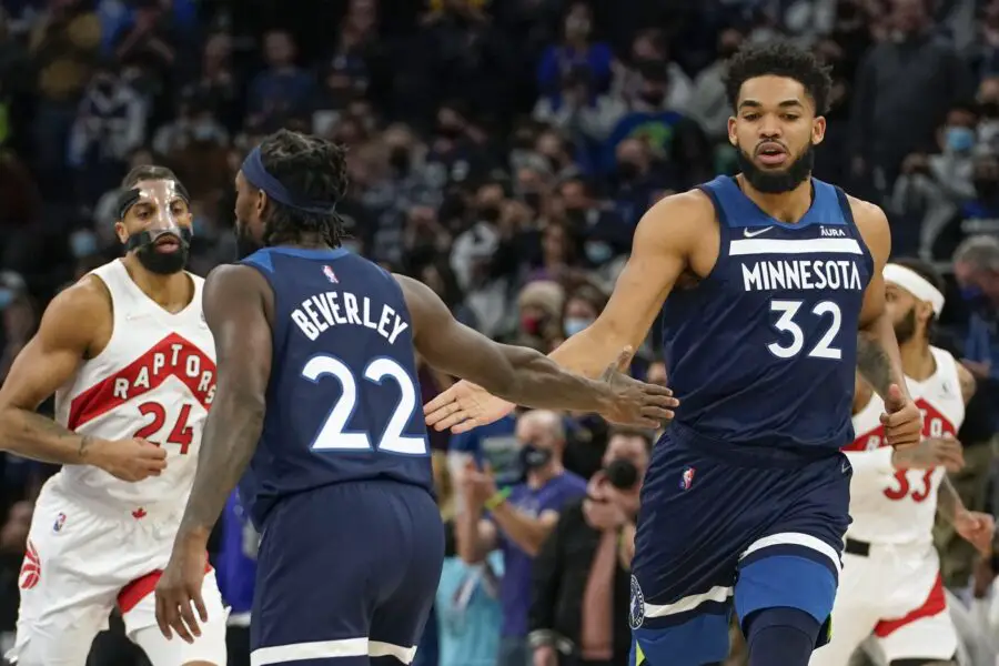 Feb 16, 2022; Minneapolis, Minnesota, USA; Minnesota Timberwolves guard Patrick Beverley (22) and center Karl-Anthony Towns (32) celebrate after a basket against the Toronto Raptors during the first quarter at Target Center. Mandatory Credit: Nick Wosika-USA TODAY Sports