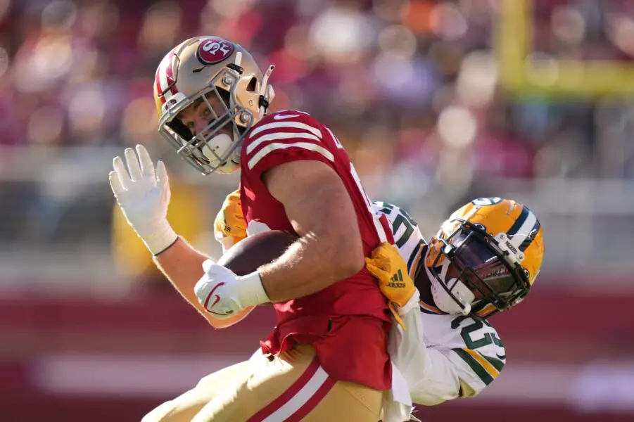 August 12, 2022; Santa Clara, California, USA; San Francisco 49ers tight end Ross Dwelley (82) is tackled by Green Bay Packers cornerback Keisean Nixon (25) during the first quarter at Levi's Stadium. Mandatory Credit: Kyle Terada-USA TODAY Sports