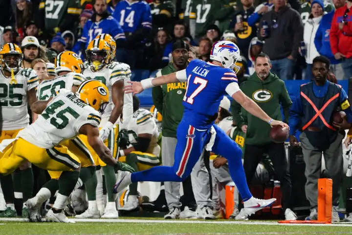 Oct 30, 2022; Orchard Park, New York, USA; Buffalo Bills quarterback Josh Allen (17) runs for a first down with Green Bay Packers linebacker Eric Wilson (45) defending during the second half at Highmark Stadium. Mandatory Credit: Gregory Fisher-USA TODAY Sports
