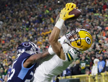 Green Bay Packers wide receiver Christian Watson (9) scores a touchdown against Tennessee Titans cornerback Kristian Fulton (26) during their game Thursday, Nov. 17, at Lambeau Field in Green Bay. © Dan Powers / USA TODAY NETWORK-Wisconsin / USA TODAY NETWORK