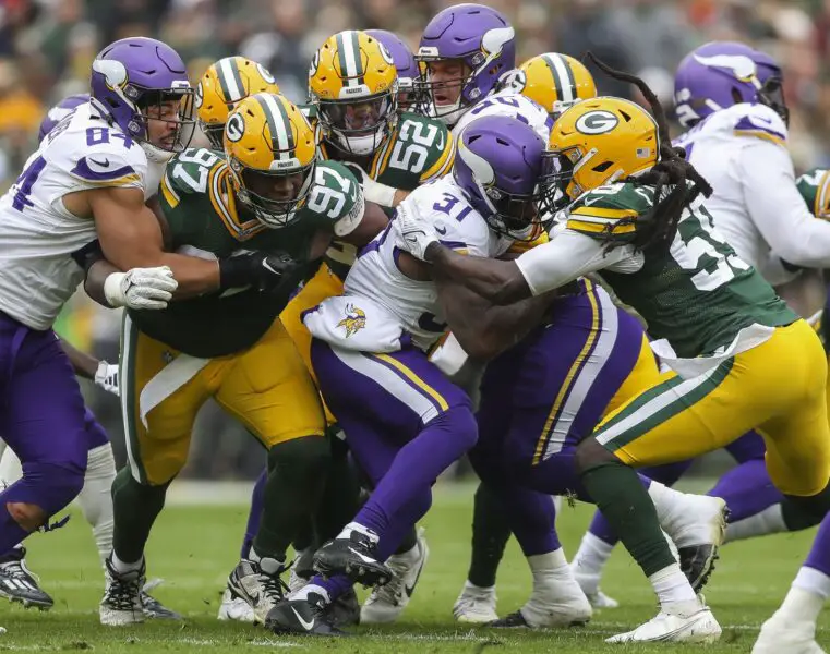 Oct 29, 2023; Green Bay, Wisconsin, USA; Minnesota Vikings running back Cam Akers (31) is tackled by Green Bay Packers defensive tackle Kenny Clark (97), linebacker Rashan Gary and linebacker De'Vondre Campbell (59) in the game at Lambeau Field. Mandatory Credit: Tork Mason-USA TODAY Sports