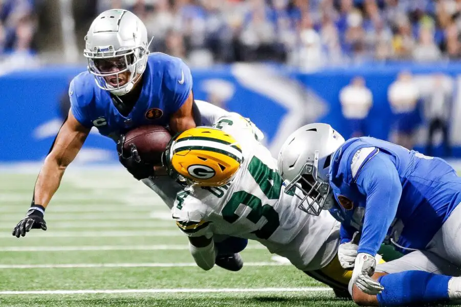 Detroit Lions receiver Amon-Ra St. Brown is tackled by Green Bay Packers safety Jonathan Owens during the second half at Ford Field in Detroit on Thursday, Nov. 23, 2023. © Junfu Han / USA TODAY NETWORK