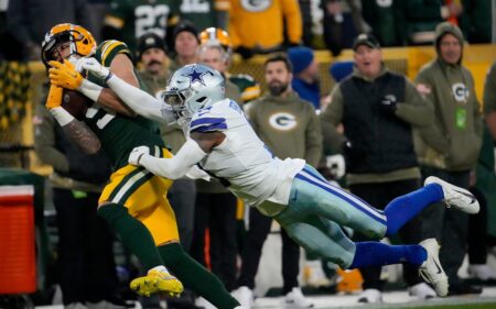 Green Bay Packers wide receiver Christian Watson (9) catches a touchdown pass as Dallas Cowboys cornerback Anthony Brown (3) defends during the first half of the Packers' 31-28 overtime win on Nov. 13, 2022 at Lambeau Field in Green Bay.