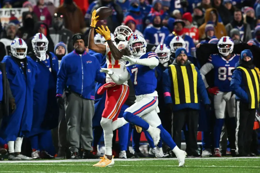Jan 21, 2024; Orchard Park, New York, USA; Kansas City Chiefs wide receiver Marquez Valdes-Scantling (11) makes a catch over Buffalo Bills cornerback Taron Johnson (7) in the first half of the 2024 AFC divisional round game at Highmark Stadium. Mandatory Credit: Mark Konezny-USA TODAY Sports